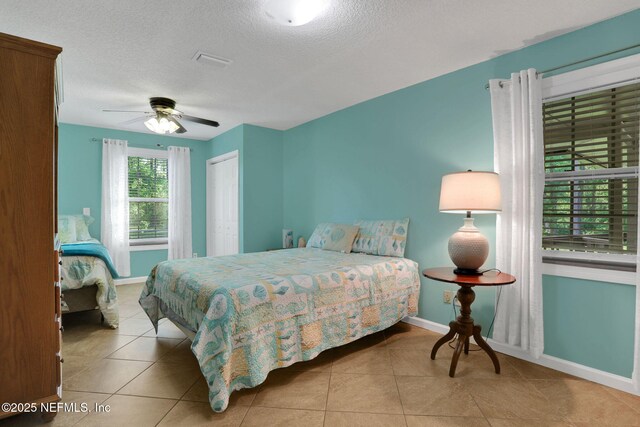 4864 County Road 218, Middleburg, FL 32068 - bedroom with tile patterned flooring, a textured ceiling, and baseboards