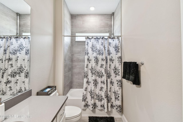 full bath with toilet, shower / bath combo with shower curtain, and vanity