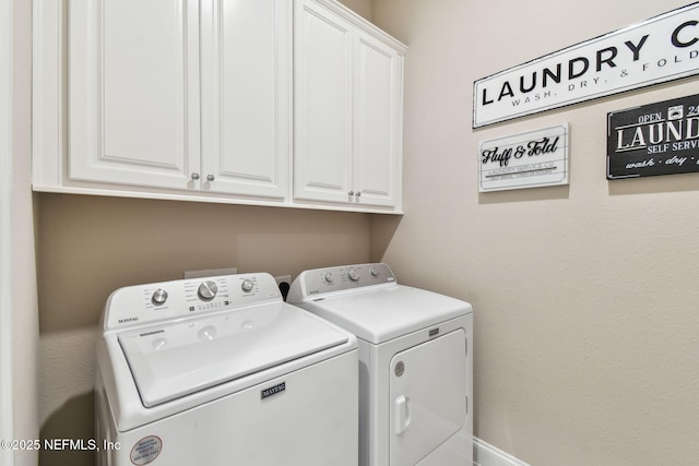 laundry area with independent washer and dryer and cabinet space