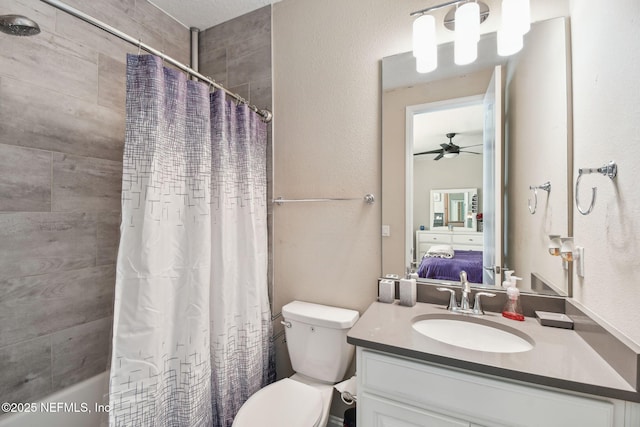 ensuite bathroom featuring ensuite bathroom, toilet, ceiling fan, shower / tub combo with curtain, and vanity