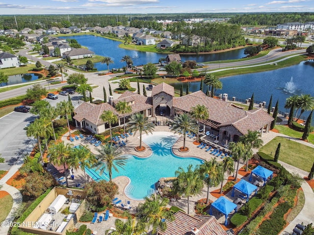 drone / aerial view featuring a water view and a residential view