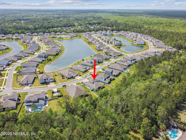 drone / aerial view featuring a residential view and a water view