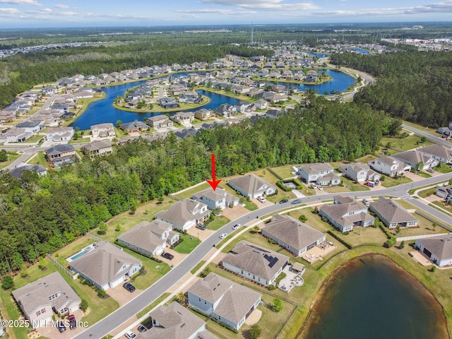 drone / aerial view featuring a water view and a residential view