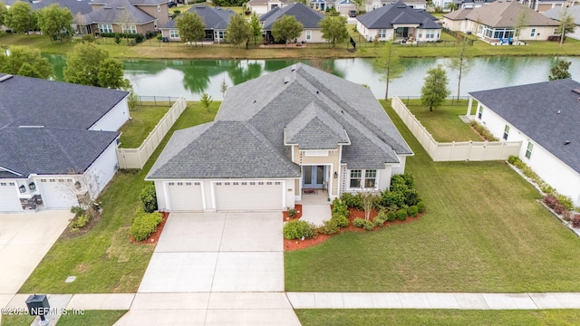drone / aerial view featuring a residential view and a water view