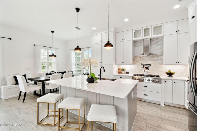258 Haas Ave, Saint Augustine, FL 32095 - kitchen with wall chimney exhaust hood, a sink, stainless steel gas cooktop, decorative backsplash, and light countertops