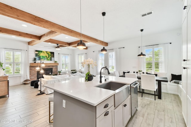 258 Haas Ave, Saint Augustine, FL 32095 - kitchen with a sink, healthy amount of natural light, light wood-style floors, beam ceiling, and a stone fireplace