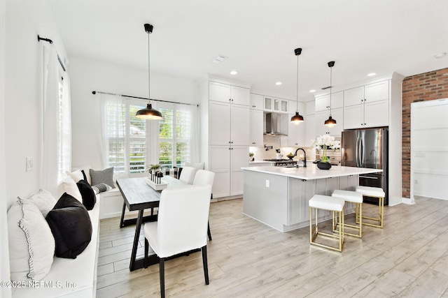 258 Haas Ave, Saint Augustine, FL 32095 - kitchen featuring wall chimney range hood, freestanding refrigerator, light countertops, white cabinets, and recessed lighting