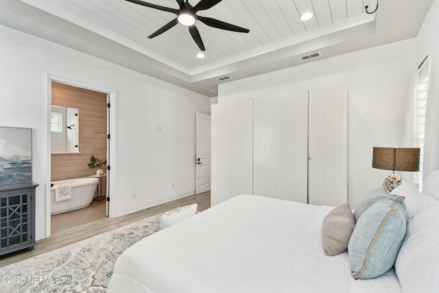 258 Haas Ave, Saint Augustine, FL 32095 - bedroom featuring a tray ceiling, light wood-style floors, recessed lighting, ensuite bathroom, and baseboards