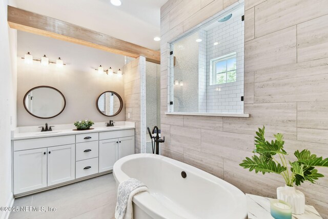 258 Haas Ave, Saint Augustine, FL 32095 - full bathroom featuring a soaking tub, double vanity, tile patterned flooring, and tiled shower