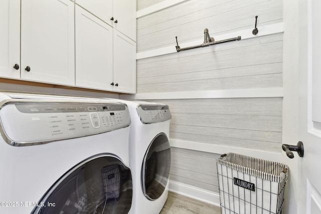 258 Haas Ave, Saint Augustine, FL 32095 - laundry room featuring washing machine and clothes dryer, cabinet space, baseboards, wood finished floors, and wooden walls