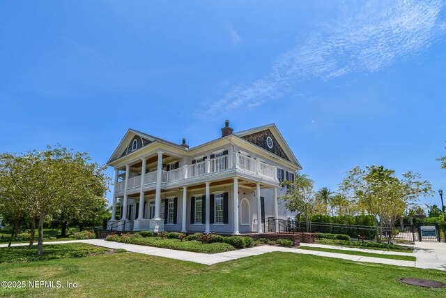 258 Haas Ave, Saint Augustine, FL 32095 - view of front facade with a balcony, a chimney, and a porch
