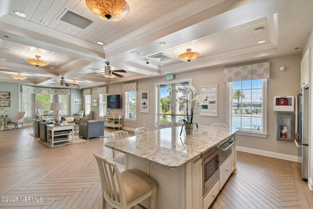 258 Haas Ave, Saint Augustine, FL 32095 - kitchen with stainless steel appliances, baseboards, a warming drawer, a ceiling fan, and light stone countertops