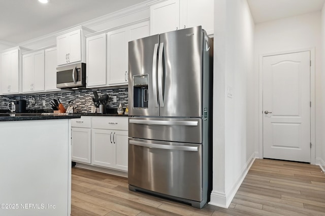3313 Loofah Pl, Green Cove Springs, FL 32043 - kitchen with light wood-style flooring, decorative backsplash, stainless steel appliances, white cabinets, and baseboards