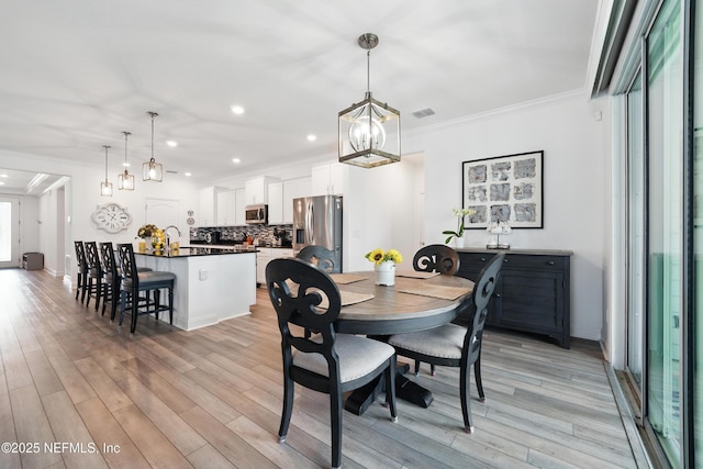 3313 Loofah Pl, Green Cove Springs, FL 32043 - dining space featuring visible vents, ornamental molding, recessed lighting, and light wood finished floors