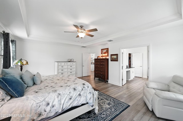 3313 Loofah Pl, Green Cove Springs, FL 32043 - bedroom with crown molding, visible vents, a tray ceiling, baseboards, and wood finished floors