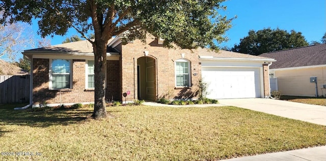 11775 Blueberry Ln, Macclenny, FL 32063 - ranch-style house featuring concrete driveway, a front yard, brick siding, a garage, and fence