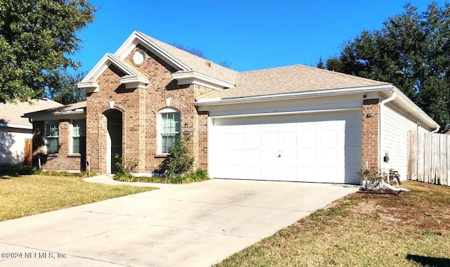 11775 Blueberry Ln, Macclenny, FL 32063 - view of front of property with concrete driveway, roof with shingles, a front lawn, brick siding, and a garage