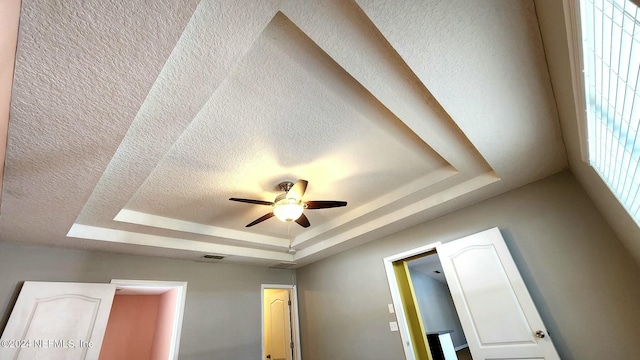 11775 Blueberry Ln, Macclenny, FL 32063 - room details featuring ceiling fan, a textured ceiling, visible vents, and a raised ceiling