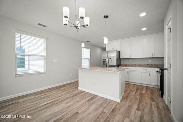 8922 Free Ave, Jacksonville, FL 32211 - kitchen with visible vents, light wood-style flooring, appliances with stainless steel finishes, and a chandelier
