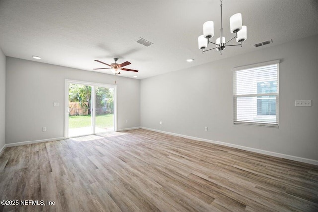 8922 Free Ave, Jacksonville, FL 32211 - unfurnished room with visible vents, wood finished floors, and ceiling fan with notable chandelier