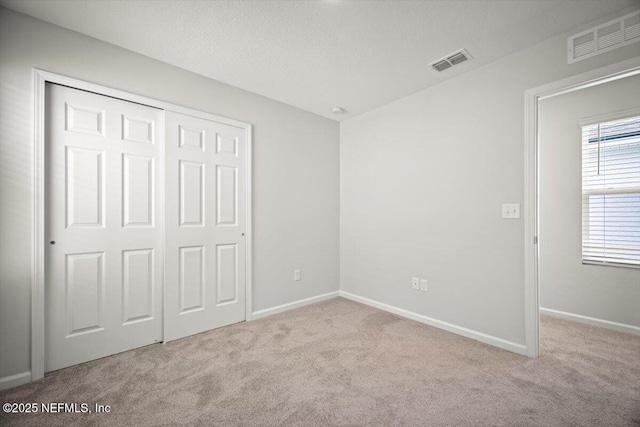 8922 Free Ave, Jacksonville, FL 32211 - unfurnished bedroom with visible vents, a closet, and carpet