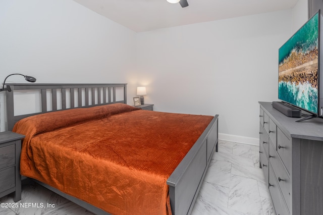 bedroom featuring baseboards, marble finish floor, and ceiling fan