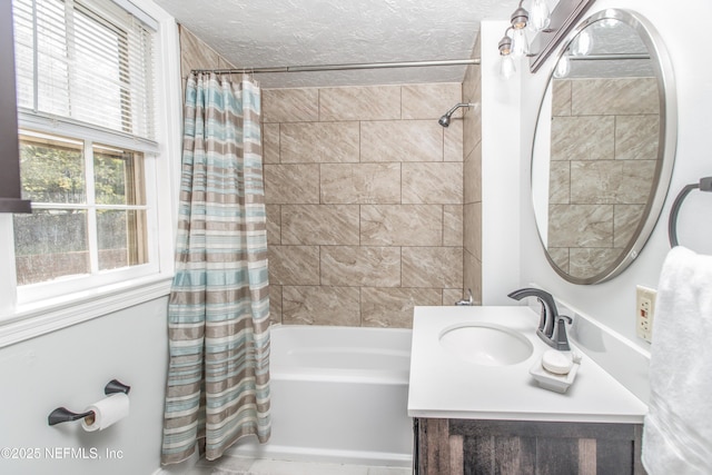 full bath featuring shower / bathtub combination with curtain, vanity, and a textured ceiling