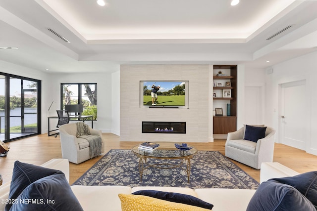 1592 Harbour Club Dr, Ponte Vedra Beach, FL 32082 - living area with a tiled fireplace, visible vents, a raised ceiling, and wood finished floors