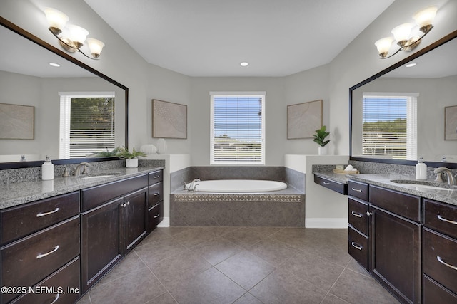 full bathroom featuring tile patterned floors, a sink, and a wealth of natural light