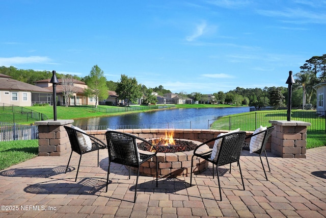 view of patio featuring a residential view, fence, and a water view