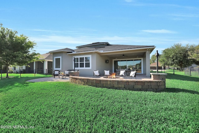 rear view of house with fence, a patio area, a ceiling fan, and a lawn