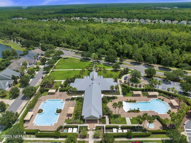 birds eye view of property featuring a wooded view