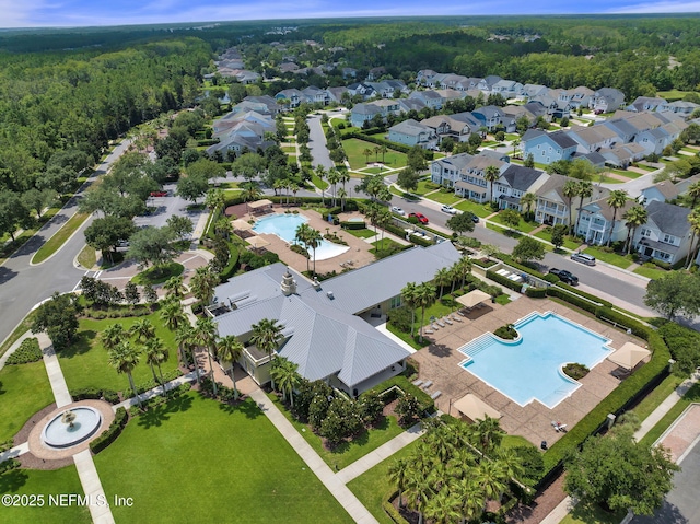birds eye view of property featuring a view of trees