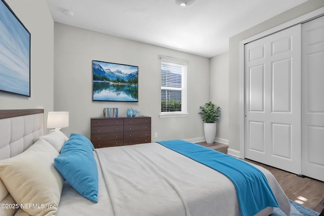 bedroom featuring a closet, baseboards, and wood finished floors