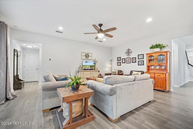 living area with light wood-style floors, recessed lighting, visible vents, and a ceiling fan