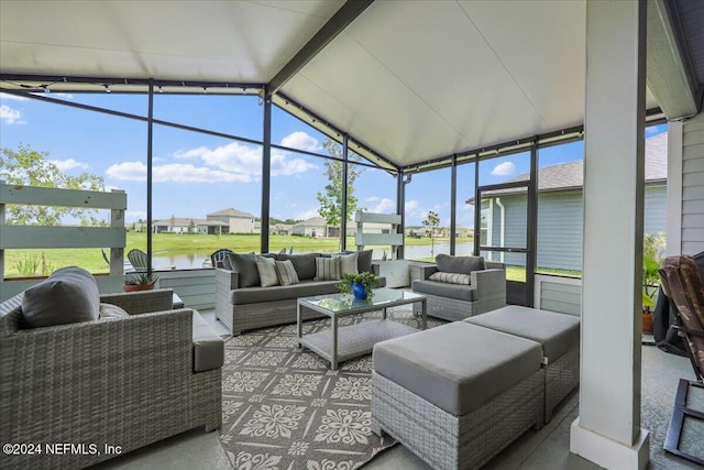 sunroom / solarium featuring a water view, outdoor lounge area, and a residential view
