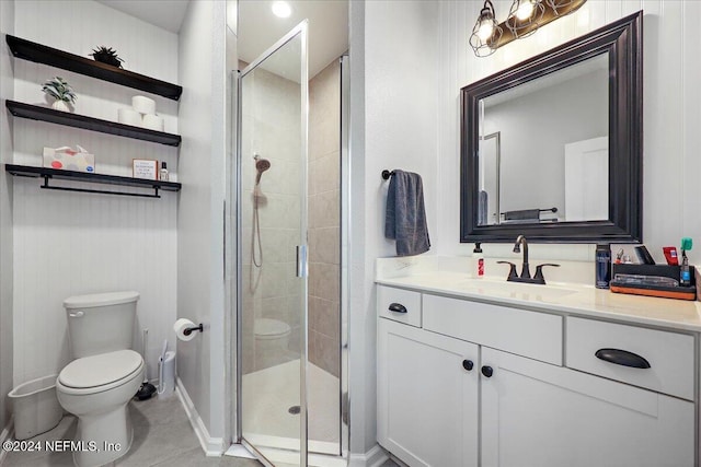 full bath with vanity, baseboards, a stall shower, tile patterned flooring, and toilet