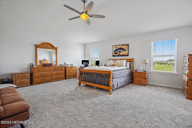 bedroom with carpet floors, ceiling fan, multiple windows, and lofted ceiling