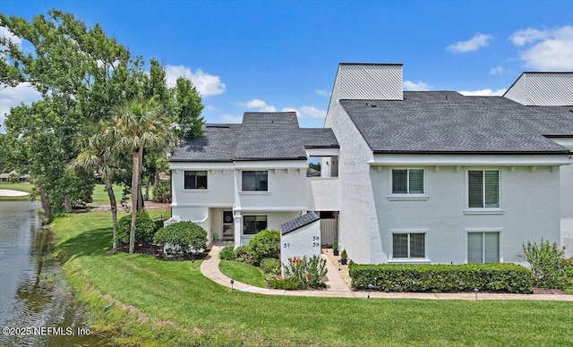 58 Tifton Way N, Ponte Vedra Beach, FL 32082 - rear view of property with stucco siding, a lawn, a water view, and roof with shingles