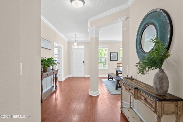 243 Olivette St, Saint Johns, FL 32259 - foyer entrance with baseboards, ornamental molding, hardwood / wood-style flooring, a textured ceiling, and ornate columns