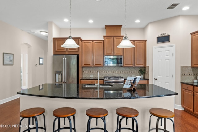243 Olivette St, Saint Johns, FL 32259 - kitchen featuring a kitchen bar, dark wood-style floors, visible vents, and stainless steel appliances
