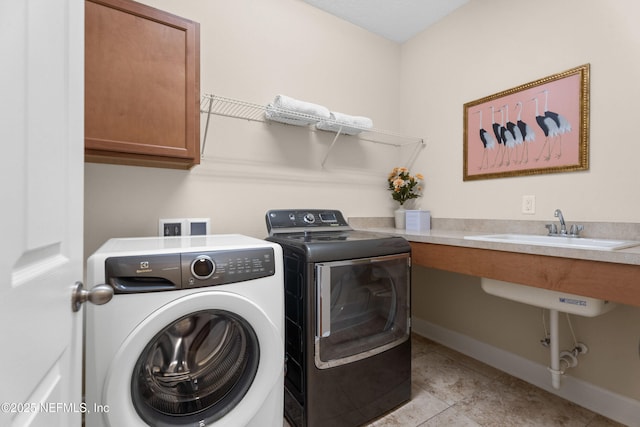 243 Olivette St, Saint Johns, FL 32259 - clothes washing area featuring baseboards, light tile patterned flooring, independent washer and dryer, cabinet space, and a sink