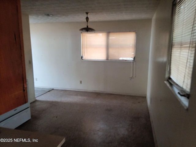 6450 San Juan Ave, Jacksonville, FL 32210 - unfurnished dining area featuring a textured ceiling and carpet flooring
