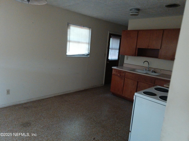 6450 San Juan Ave, Jacksonville, FL 32210 - kitchen with a textured ceiling, light countertops, a sink, electric stove, and brown cabinets