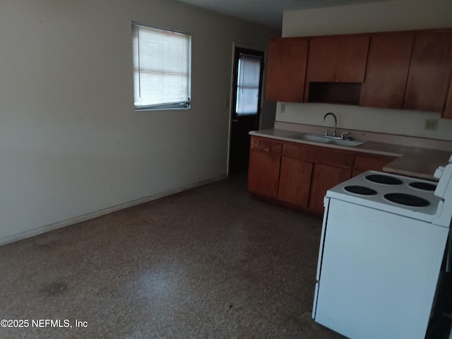6450 San Juan Ave, Jacksonville, FL 32210 - kitchen featuring brown cabinetry, light countertops, a sink, and electric range
