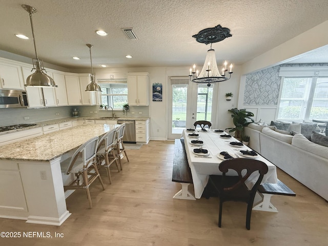 45 Princess Dr, Ponte Vedra, FL 32081 - dining space featuring light wood-type flooring, a textured ceiling, visible vents, recessed lighting, and a chandelier