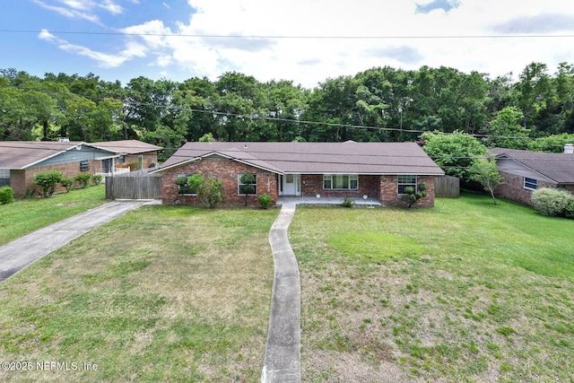 10870 High Ridge Rd, Jacksonville, FL 32225 - ranch-style home with a front yard, brick siding, driveway, and fence