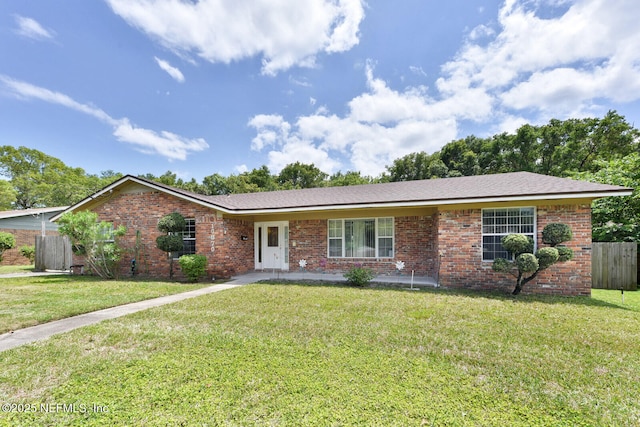 10870 High Ridge Rd, Jacksonville, FL 32225 - ranch-style house featuring a front yard, brick siding, and fence