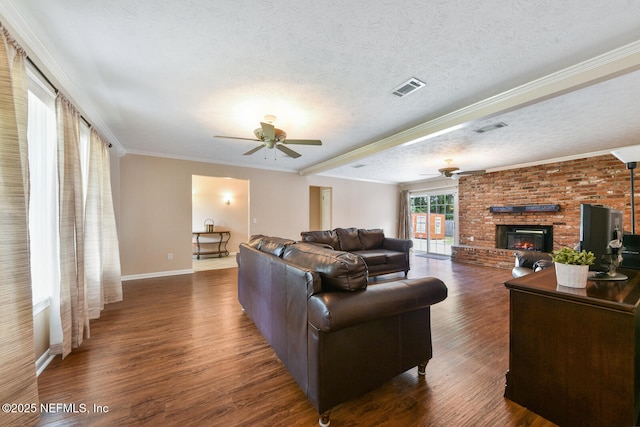 10870 High Ridge Rd, Jacksonville, FL 32225 - living area featuring dark wood-type flooring, visible vents, a ceiling fan, and a brick fireplace