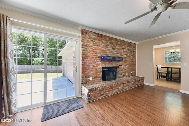 10870 High Ridge Rd, Jacksonville, FL 32225 - unfurnished living room featuring a textured ceiling, crown molding, a brick fireplace, ceiling fan with notable chandelier, and wood finished floors